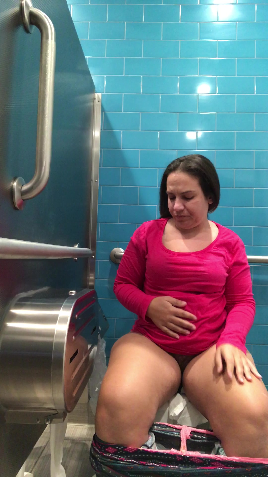 Pink shirt woman public toilet poop photo