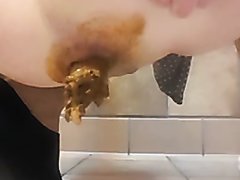 Woman poops on the floor and pees in the toilet
