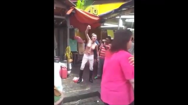 Thai hooker walks around the marketplace topless