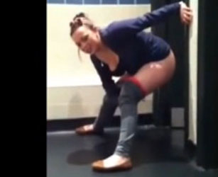 College girl tickling on the floor of public WC