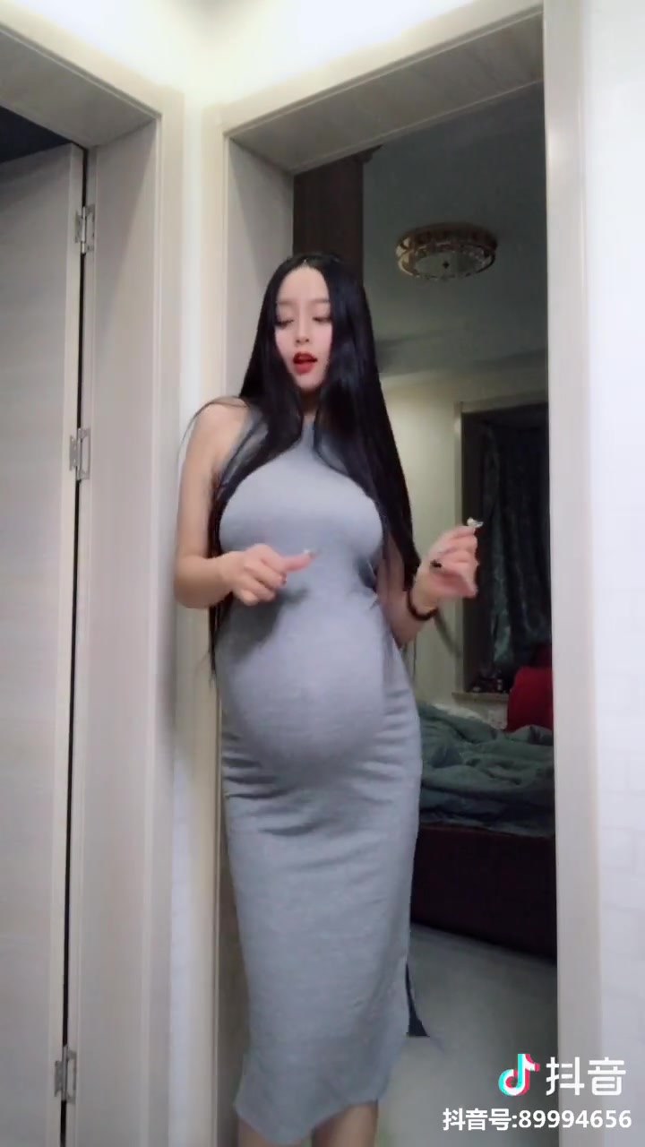 Pretty Chinese pregnant girl dancing