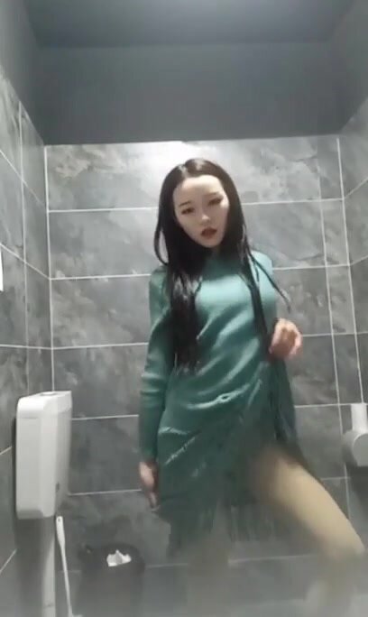 Pissing woman spied in a toilet by hidden camera