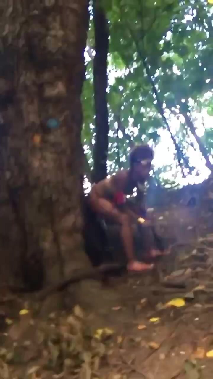 Man catches girl peeing by a tree