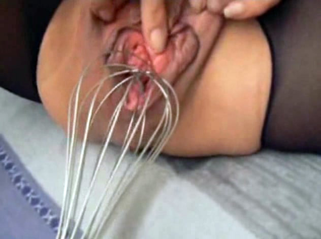 Whisk in her pussy spreads her lips wide open