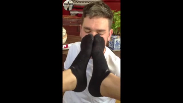Smelling his friend's socks