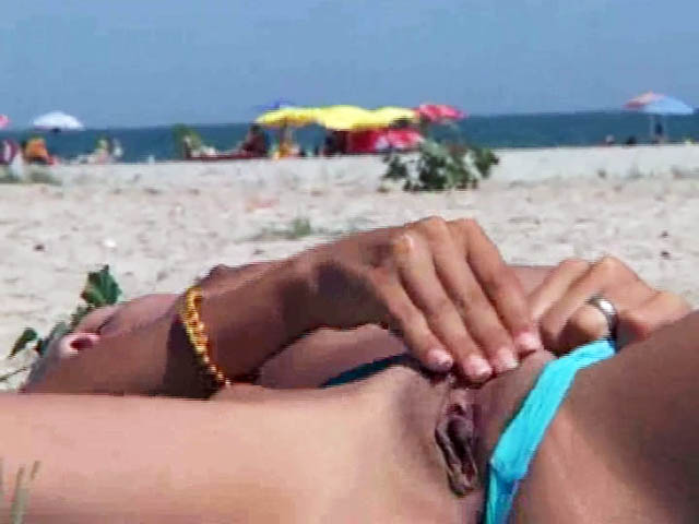 Wife masturbates and pisses on a beach towel