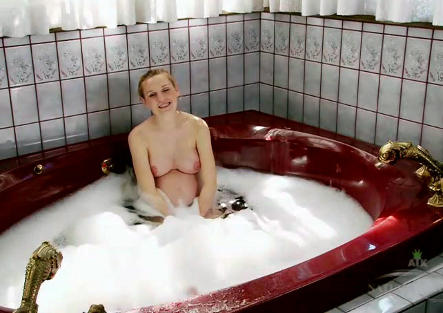 Beautiful pregnant blonde in the bathtub