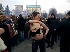 Bulgarian girl dancing in a crowd takes her top off