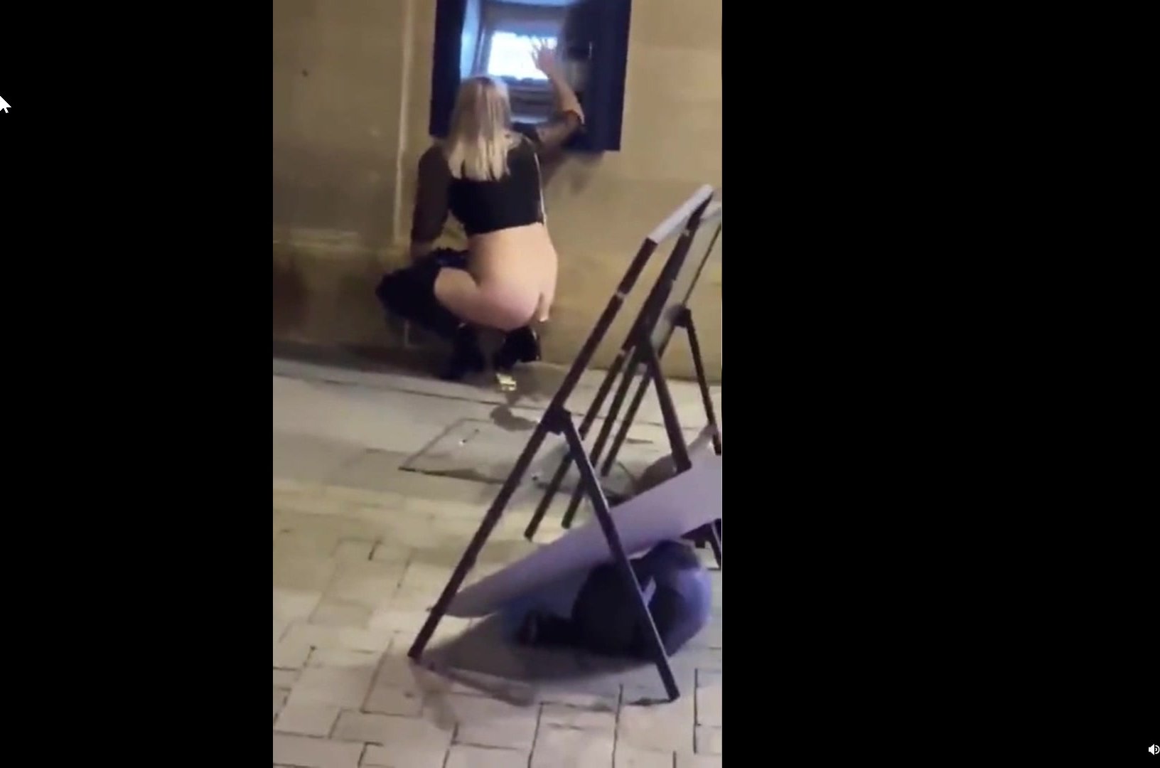Woman peeing on the street while using pic