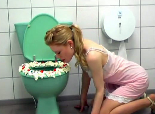 Gorgeous blonde licks whipped cream off toilet seat