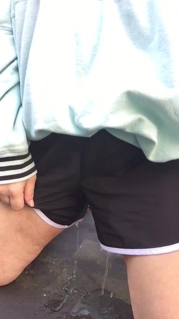 Girl peeing her black shorts