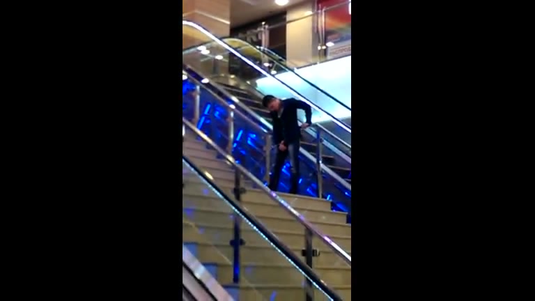 Drunk guy pissing on the stairs at the mall