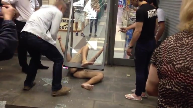 Drunk naked guy ran through a glass door