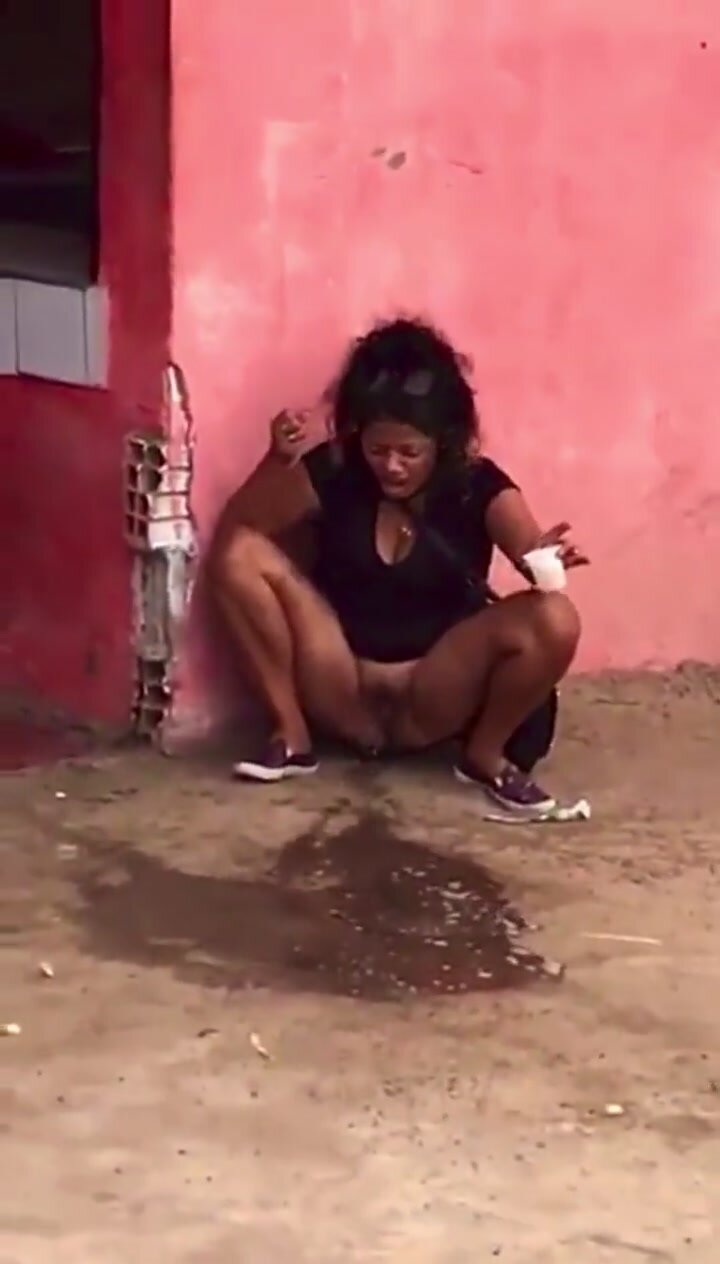 South American girl peeing outside her home