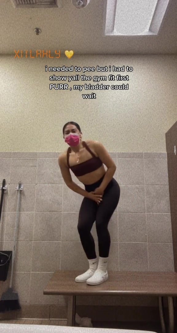 Tiktok girl holding to show gym outfit