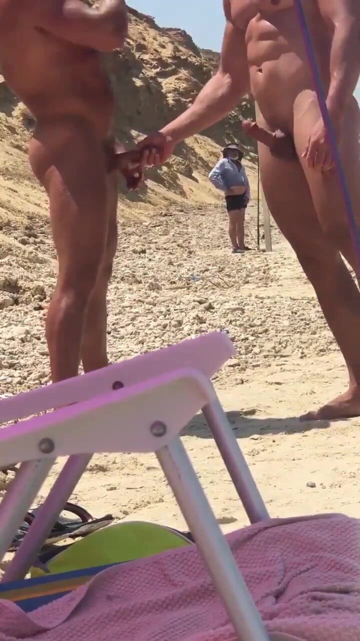 Guys stroking eachother at public beach - ThisVid.com