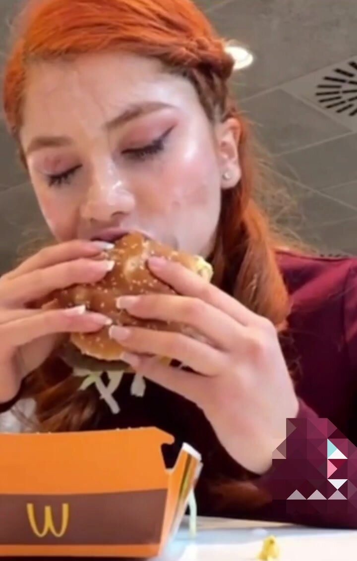 Pretty girl eating McD with cum on her face pic