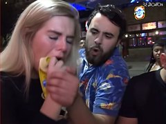 Fantastic girl swallows a banana in the street