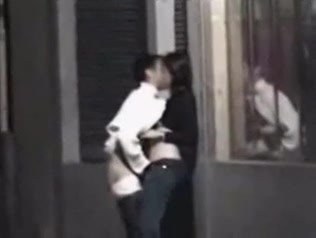 Couple getting frisky on the street