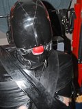 Locked in subsuit with collar and gag also locked on - rubber strip restraining arms