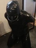 Tables were turned - hands cuffed behind back and piss hood forced on and locked to suit ... somewhat unhappy