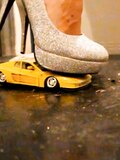 Sexy girl crush toy car in high heels