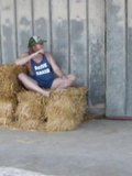 just wearing my long tank top but showing everything while sitting on a few hay bales at the feed store