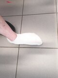 Shoeless on a public Toilet