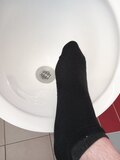 Shoeless on a public Toilet