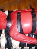 Restrained in a red rubbersuit