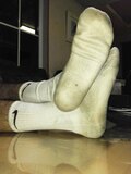 Man in dirty white crew socks