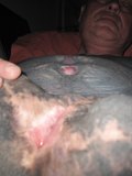 Black tattooed man with bisected cock