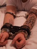 Guys with tattoo handcuffed