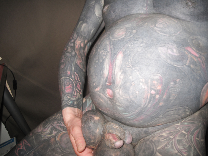 Black tattooed man with bisected cock