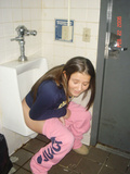 Girls peeing in urinals