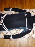 Restrained in a neoprene diver suit