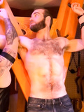 Shirtless male bondage on hairy chested guy