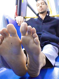 ANOTHER DUDE ON BUS SHOWS HIS FEET