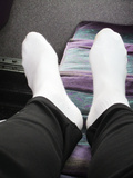 Dirty white socks on the bus