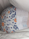Real incontinent girl wears diaper in bed