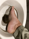Dirty feet on toilet
