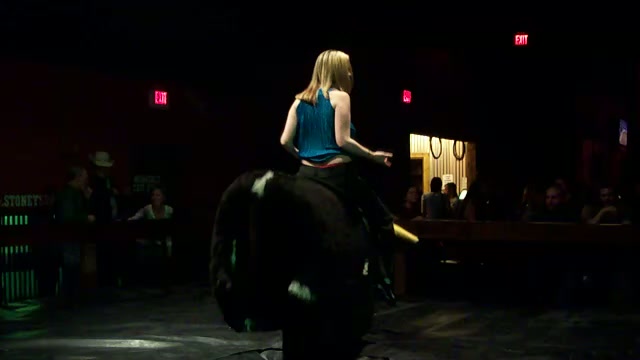 Riding a bull blonde showing boobs