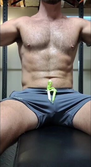 Sexy hunk man is flashing his dick during workout