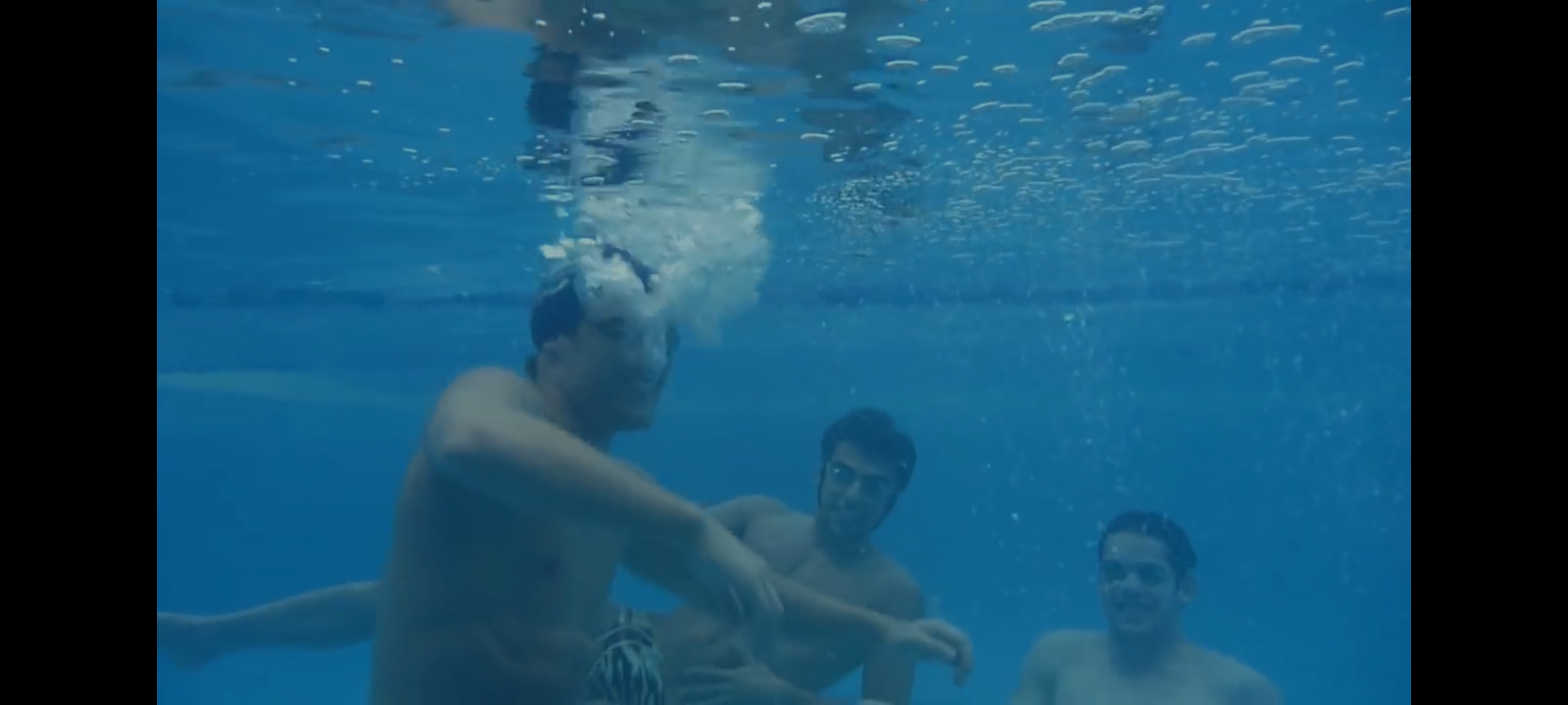 3 swimmers having fun underwater
