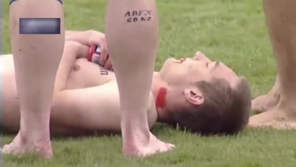 NAKED FOOTBALLER CARRIED OFF FIELD