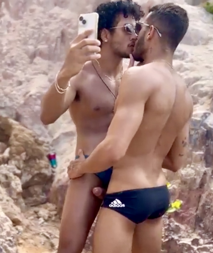 Hot guys kissing at the beach