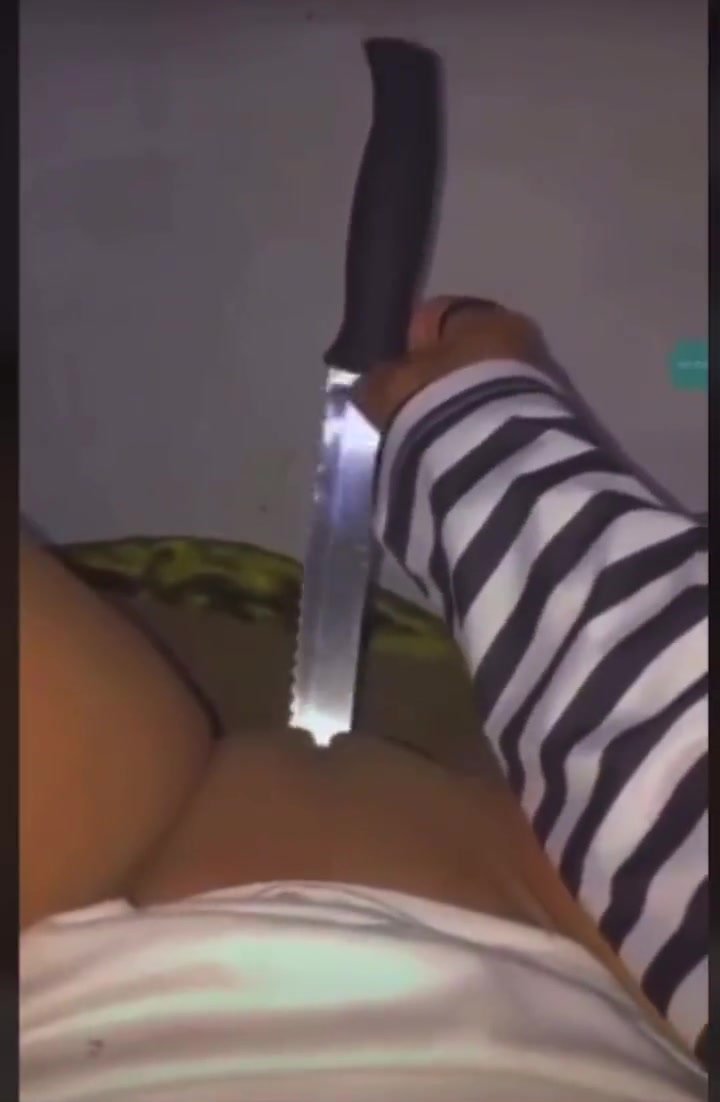 Horny ebony masturbates with a rigid knife
