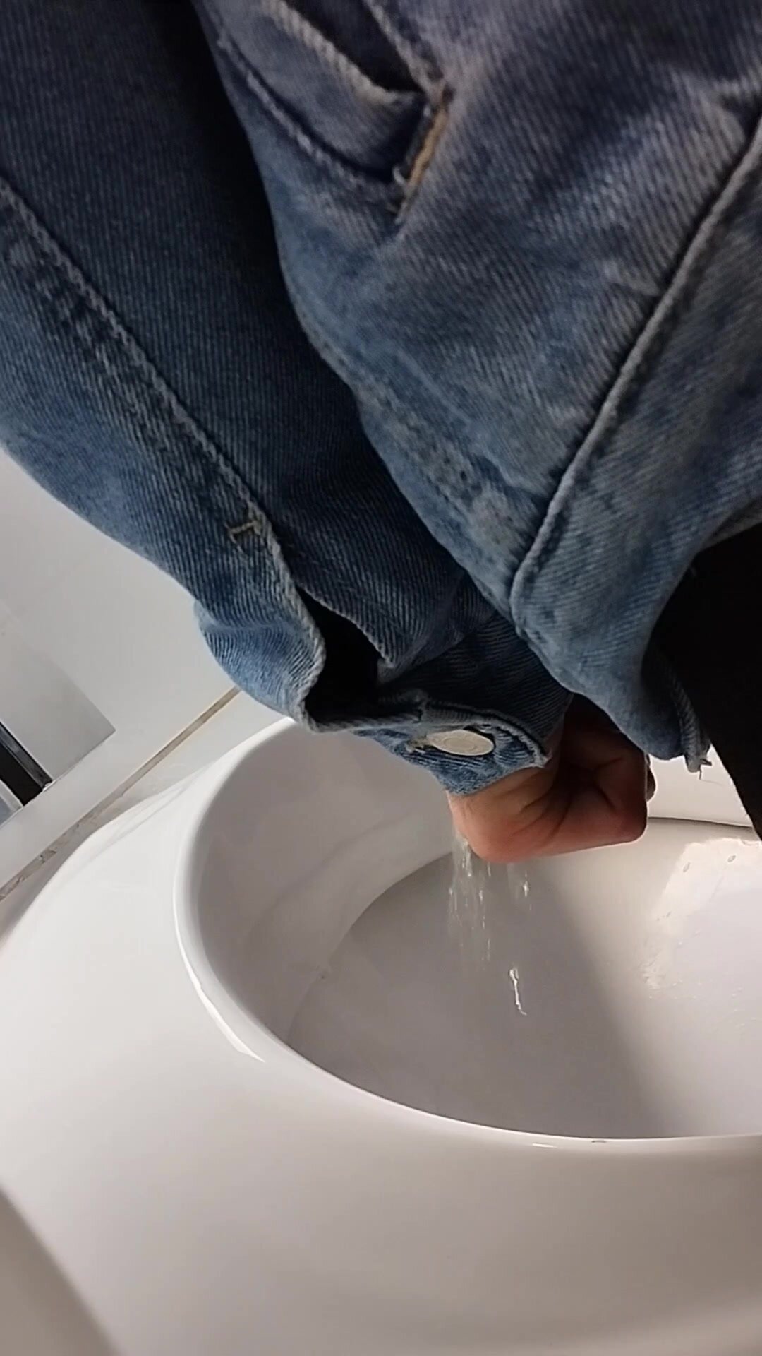 A young guy pisses at the urinal - video 42
