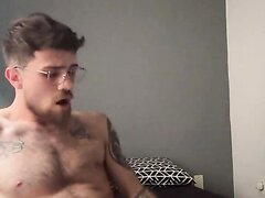 Bearded guy in glasses covers his hairy body in cum