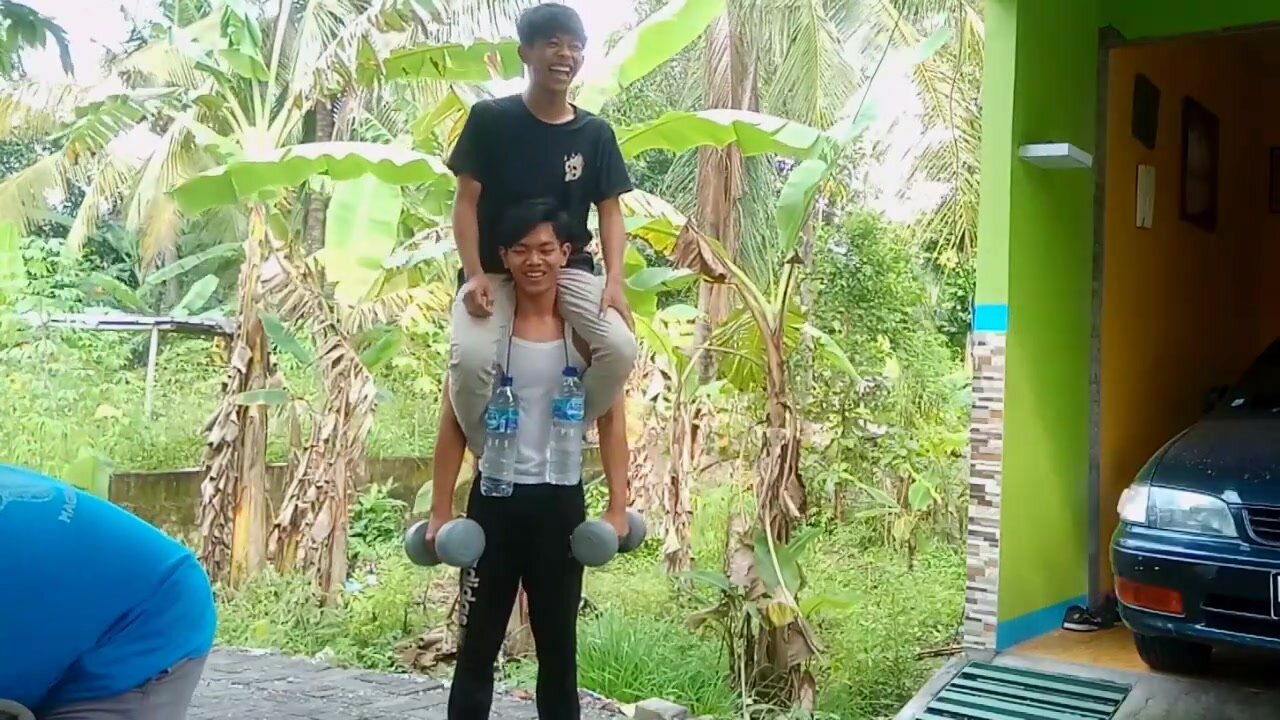 Carry asian man with dumbells and other weights
